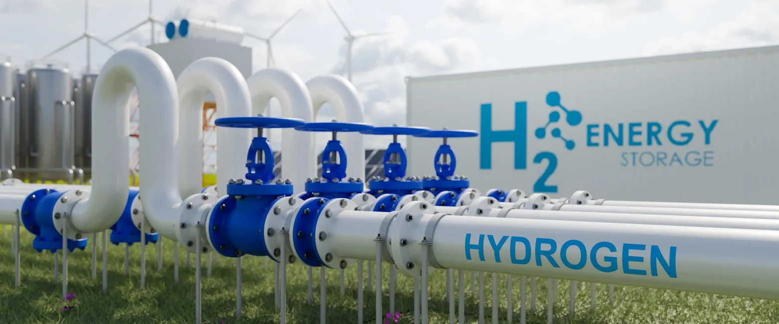 Pipes labeled "Hydrogen" lead to an energy storage facility, with wind turbines and storage tanks in the background.