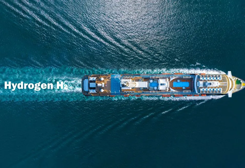 Aerial view of a ship labeled "Hydrogen H₂" sailing through blue water, leaving a visible wake behind.